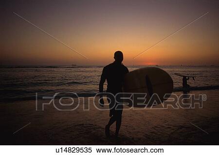 Surfers at the Evening Beach View Large Photo Image Stock Photography - Surfers at the Evening Beach. Fotosearch
