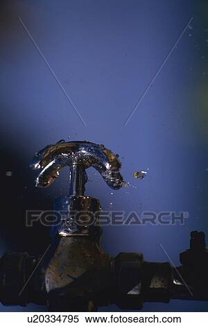 Stock Photography - Water Drops fall to the Faucet, Side View. Fotosearch