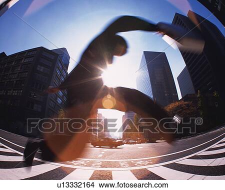 Businessman Jumping, Low Angle View, Lens Flare, Long Exposure, Fish Eye View Large Photo Image Picture - Businessman Jumping, Low Angle View, Lens Flare, Long Exposure, Fish Eye. Fotosearch