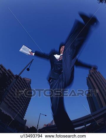 Businessman Jumping, Low Angle View, Long Exposure View Large Photo Image Picture - Businessman Jumping, Low Angle View, Long Exposure. Fotosearch