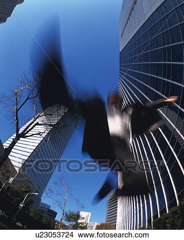 Businessman Jumping, Low Angle View, Long Exposure View Large Photo Image Picture - Businessman Jumping, Low Angle View, Long Exposure. Fotosearch
