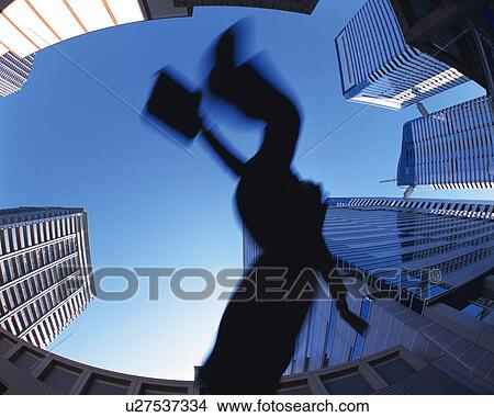 Picture - Businessman Jumping, Low Angle View, Long Exposure, Fish Eye. Fotosearch