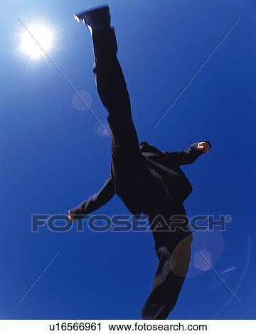 Businessman Jumping, Low Angle View, Lens Flare, Long Exposure View Large Photo Image Stock Image - Businessman Jumping, Low Angle View, Lens Flare, Long Exposure. Fotosearch