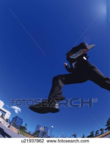 Businessman Jumping, Low Angle View, Long Exposure, Copy Space View Large Photo Image Stock Image - Businessman Jumping, Low Angle View, Long Exposure, Copy Space. Fotosearch