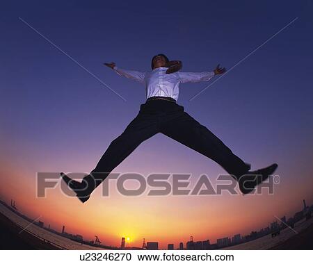Businessman Jumping, Low Angle View, Long Exposure, Fish Eye View Large Photo Image Stock Image - Businessman Jumping, Low Angle View, Long Exposure, Fish Eye. Fotosearch