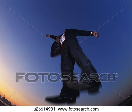 Businessman Jumping, Low Angle View, Long Exposure View Large Photo Image Stock Image - Businessman Jumping, Low Angle View, Long Exposure. Fotosearch