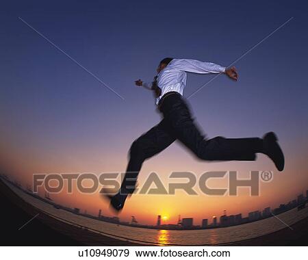 Stock Photo - Businessman Jumping, Low Angle View, Long Exposure, Fish Eye. Fotosearch