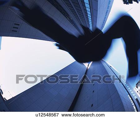 Stock Photo - Businessman Jumping, Low Angle View, Long Exposure. Fotosearch