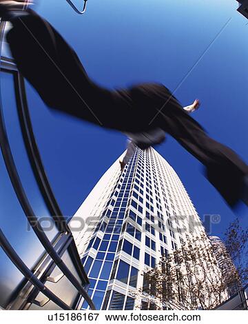 Businessman Jumping, Low Angle View, Long Exposure, Fish Eye View Large Photo Image Stock Photo - Businessman Jumping, Low Angle View, Long Exposure, Fish Eye. Fotosearch