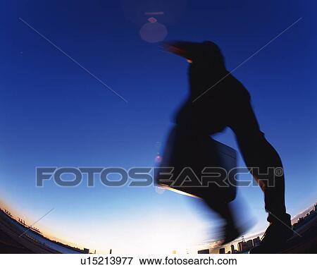 Stock Photo - Businessman Jumping, Low Angle View, Lens Flare, Long Exposure, Fish Eye, Copy Space. Fotosearch