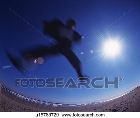 Stock Photo - Businessman Jumping, Low Angle View, Lens Flare, Long Exposure, Fish Eye. Fotosearch