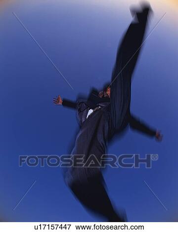 Businessman Jumping, Low Angle View, Long Exposure, Copy Space View Large Photo Image Stock Photo - Businessman Jumping, Low Angle View, Long Exposure, Copy Space. Fotosearch