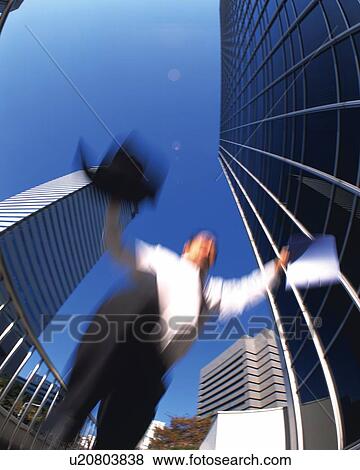 Businessman Jumping, Low Angle View, Lens Flare, Long Exposure, Fish Eye View Large Photo Image Stock Photo - Businessman Jumping, Low Angle View, Lens Flare, Long Exposure, Fish Eye. Fotosearch
