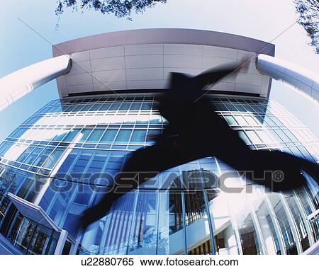 Stock Photography - Businessman Jumping, Low Angle View, Lens Flare, Long Exposure, Fish Eye. Fotosearch