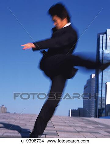 Picture - Businessman Kicking, Front View, Long Exposure. Fotosearch