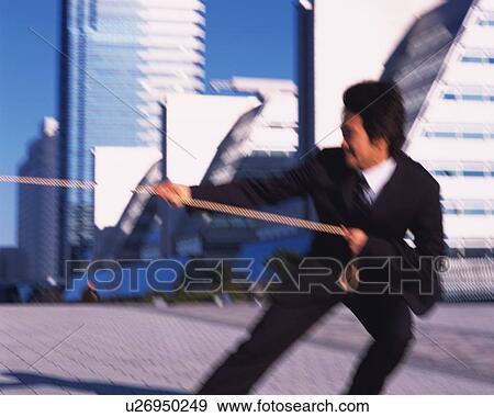 Businessman Pulling Rope, Side View, Blurred Motion View Large Photo Image Stock Photo - Businessman Pulling Rope, Side View, Blurred Motion. Fotosearch