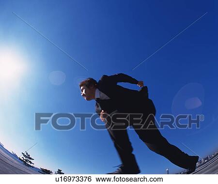 Businessman Running, Low Angle View, Lens Flare, Long Exposure, Fish Eye, Copy Space View Large Photo Image Stock Photograph - Businessman Running, Low Angle View, Lens Flare, Long Exposure, Fish Eye, Copy Space. Fotosearch
