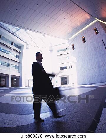 Businessman Walking, Low Angle View, Long Exposure View Large Photo Image Stock Image - Businessman Walking, Low Angle View, Long Exposure. Fotosearch