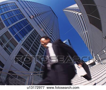 Businessman Walking, Low Angle View, Long Exposure, Fish Eye View Large Photo Image Stock Photo - Businessman Walking, Low Angle View, Long Exposure, Fish Eye. Fotosearch