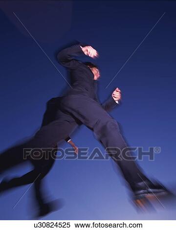 Stock Photography - Two Businessmen Jumping, Low Angle View, Long Exposure. Fotosearch