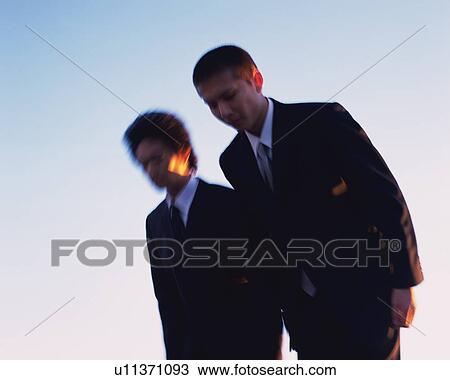 Two Businessmen, Low Angle View, Long Exposure View Large Photo Image Stock Image - Two Businessmen, Low Angle View, Long Exposure. Fotosearch