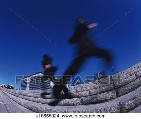 Two Businessmen Running, Low Angle View, Long Exposure View Large Photo Image Picture - Two Businessmen Running, Low Angle View, Long Exposure. Fotosearch