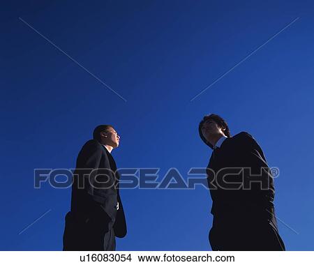 Picture - Two Businessmen Standing, Side View, Low Angle View, Copy Space. Fotosearch