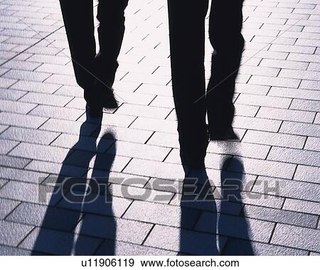 Two Businessmen Walking, High Angle View, Long Exposure View Large Photo Image Stock Photo - Two Businessmen Walking, High Angle View, Long Exposure. Fotosearch