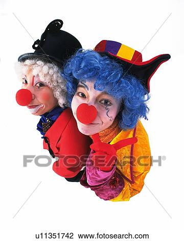 Stock Image - High Angle View of Clown Holding Flowers of Balloon, Portrait. Fotosearch