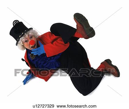Stock Photo - Portrait of Clown Gesturing, Lying, High Angle View. Fotosearch