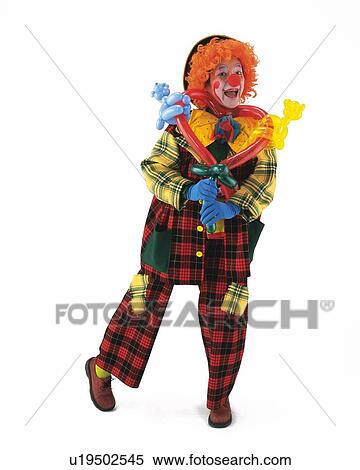 Stock Photography - Portrait of Clown Holding Balloons, Front View. Fotosearch