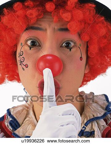 Stock Photograph - Portrait of Clown Holding Finger To Lips, Indicating 'quiet', Front View, Close Up. Fotosearch