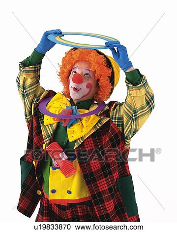 Stock Image - Portrait of Clown Holding Paper Ring, Looking Up, Front View. Fotosearch