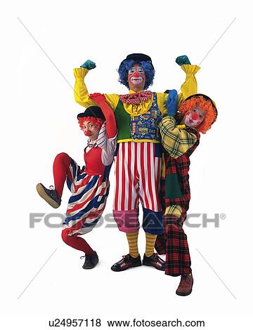 Stock Photo - Portrait of Clown Holding Two Clowns By Arms, Front View. Fotosearch