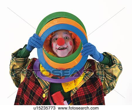Stock Image - Portrait of Clown Looking From Ring Frames, Front View. Fotosearch