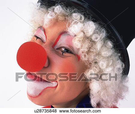 Stock Photo - Portrait of Clown Making A Face, Wink, Side View, Close Up. Fotosearch