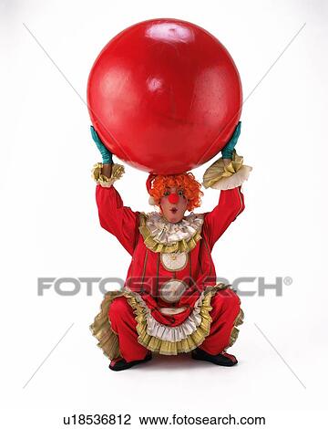 Stock Image - Portrait of Clown Posing, Holding Red Ball, Front View,. Fotosearch