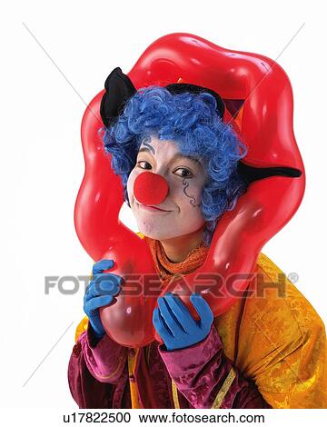 Stock Image - Portrait of Clown Putting On Head From Balloon Frame, Front View. Fotosearch