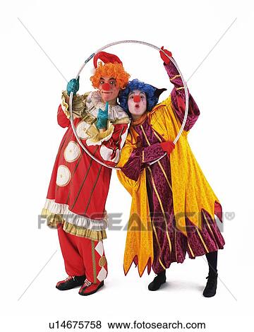 Stock Photo - Portrait of Clowns Gesturing, Holding Paper Ring, Front View. Fotosearch