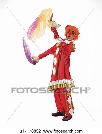 Stock Image - Portrait of Clowns Holding Clothes, Side View. Fotosearch