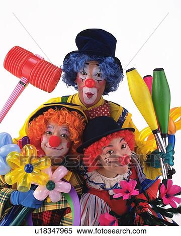 Stock Photography - Portrait of Clowns Holding Flowers of Balloon, Clubs and Hammer, Front View . Fotosearch
