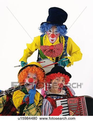 Stock Image - Portrait of Clowns Plying Drum, Clarinet, Drum, Front View . Fotosearch