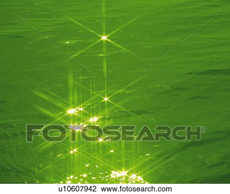 Stock Image - Glittering Water, High Angle View, Close Up, Lens Flare, Toned Image. Fotosearch