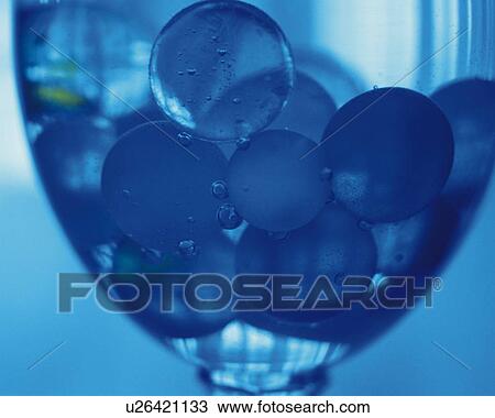 Stock Image - Marbles in the Glass, Close Up, Differential Focus, In Focus, Out Focus, Toned Image,. Fotosearch