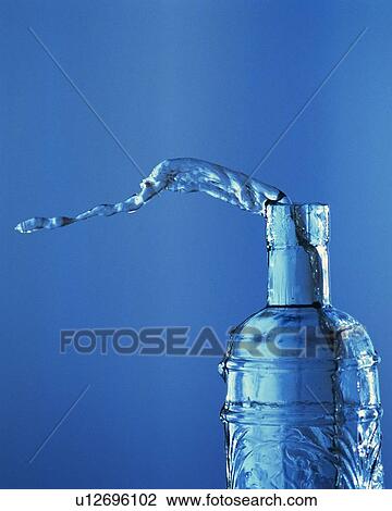 Stock Image - Water Spilling Out From a Bottle, Front View, Close Up. Fotosearch