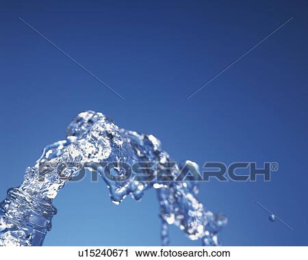 Stock Image - Gushing Water out of Bottle, Close Up, Differential Focus, In Focus, Out Focus, Copy Space. Fotosearch
