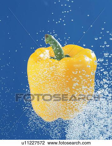 Stock Image - Yellow Paprika and Splash, Close Up, Front View, . Fotosearch