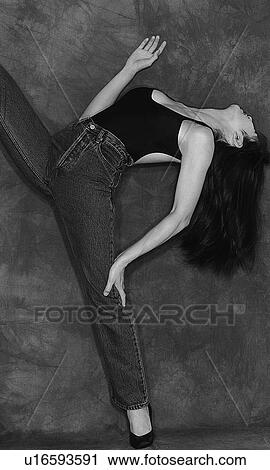 Stock Image - Portrait of a woman bending over backwards, black and white, side view. Fotosearch
