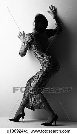 Woman in dress posing, black and white, rear view, white background View Large Photo Image Stock Photography - Woman in dress posing, black and white, rear view, white background. Fotosearch