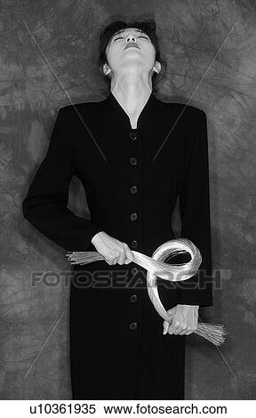 Woman looking up and holding bunch of strings, black and white, front view View Large Photo Image Stock Photography - Woman looking up and holding bunch of strings, black and white, front view. Fotosearch
